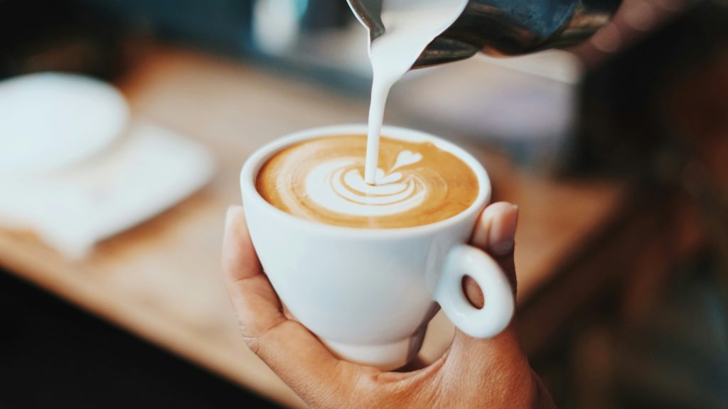 milk being poured into a latter