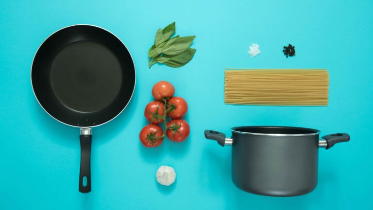 Frying pan, cooking pot, tomatoes, basil, pasta, garlic, salt pepper